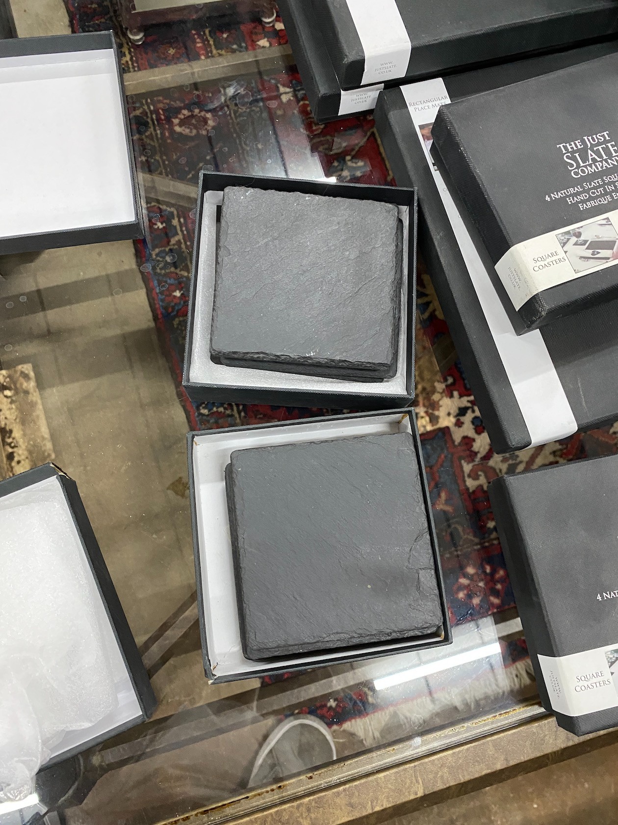 A quantity of 'The Just Slate Company' table mats, runners and coasters, all boxed
